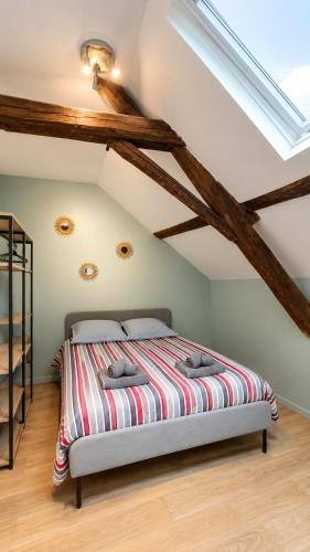a bedroom with a bed in a attic at Le Clos Delobel in Tourcoing