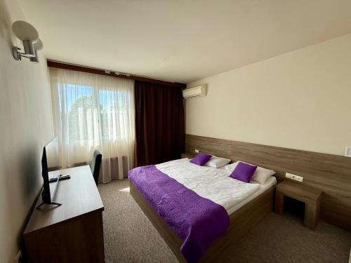 a hotel room with a bed and a television at Hotel Kutina in Kutina
