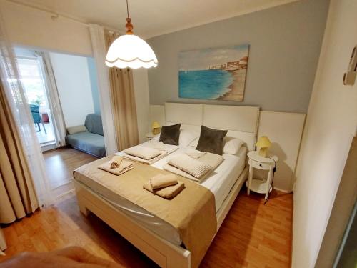 a bedroom with a large bed in a room at Rooms and apartments PALMA B&B in Medulin