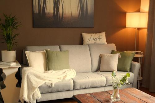 a living room with a couch and a table at Happywild in Schlangenbad