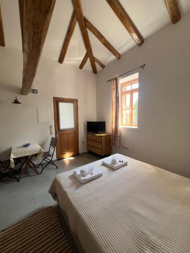 a bedroom with a bed with two towels on it at Linos Old Barn in Theológos