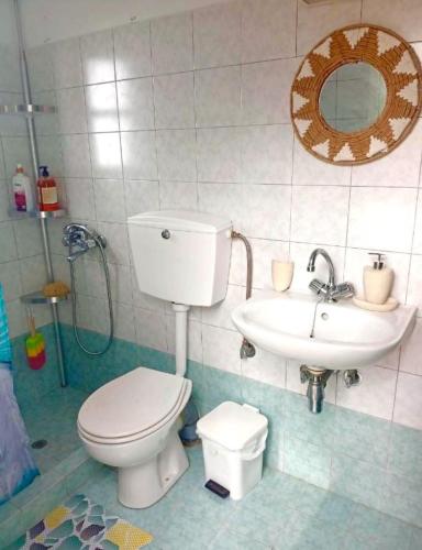 a bathroom with a toilet and a sink at Lefkiani House in Katapola