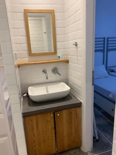 a bathroom with a sink and a mirror at Villa Thalassa - Vathy in Sifnos