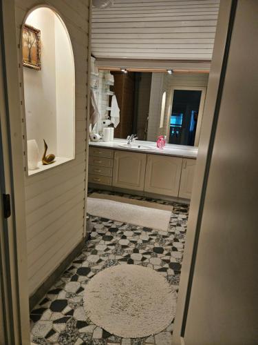 a bathroom with a sink and a mirror at Villa Gargano in Pieksämäki