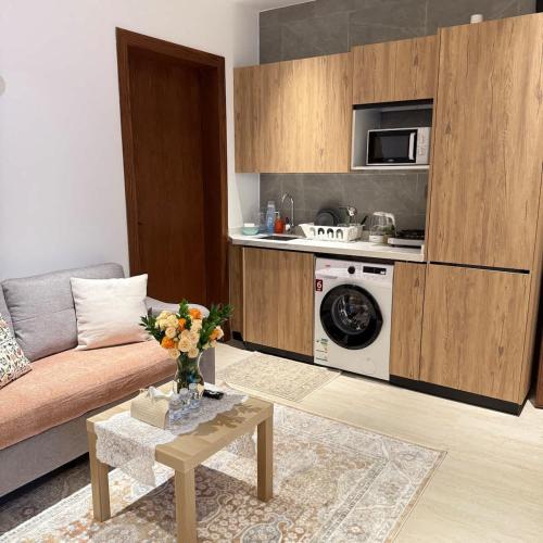 a living room with a couch and a table at Bali island Home2 in Al Khobar