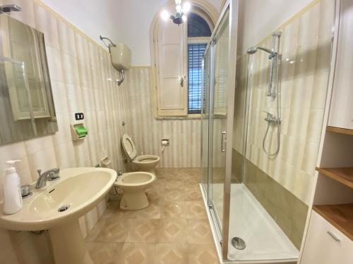 a bathroom with a sink and a toilet and a shower at Salento mare in Casalabate