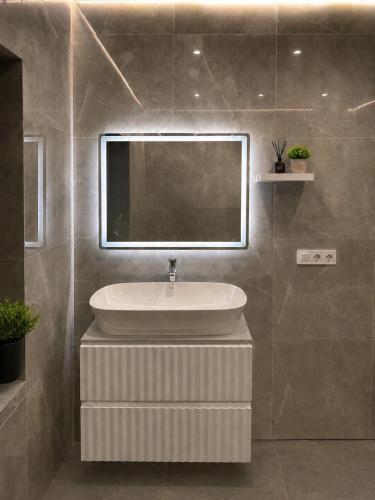 a bathroom with a sink and a mirror at Graphite House in Kyiv