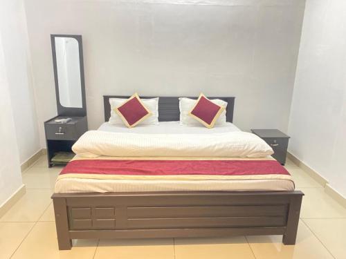 a bedroom with a large bed with two night stands at Sea Breeze Residency in Kozhikode