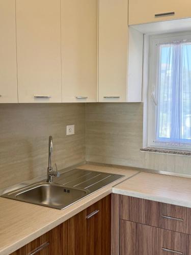 a kitchen with a sink and a window at Villa 3 in Velipojë
