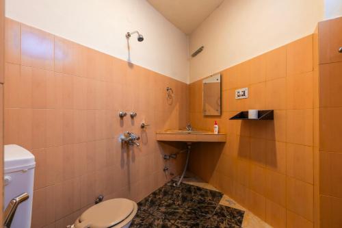 a bathroom with a toilet and a sink at RWACHO Hostel The Base in Leh