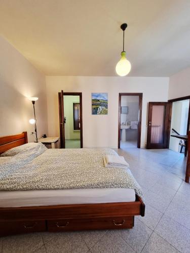 a bedroom with a large bed and a light at La Roccia Rossa in Stribugliano
