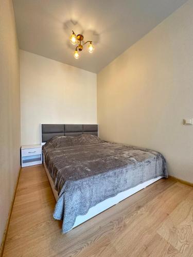a bedroom with a bed and a ceiling fan at квартира in Odesa