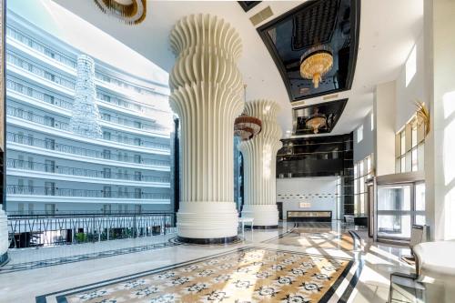 a lobby with columns and a large building at Maxihomes Snitch in Kemerağzı