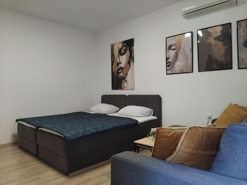 a living room with two beds and a couch at Apartman Vanja in Rijeka