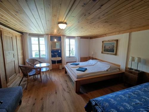 a bedroom with a bed and a table and chairs at Bergengel in Scharnachtal 