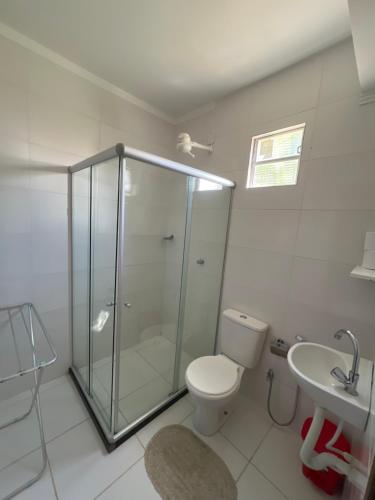 a bathroom with a shower and a toilet and a sink at Kitnet em Santo Antônio in Mata de Sao Joao