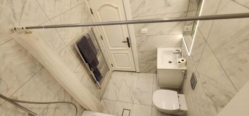 a white bathroom with a toilet and a sink at Horizon 4 - Amman in Amman