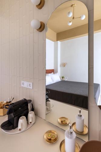 a bedroom with a bed and a mirror on a counter at Alexander Seaview Haven in Ermoupoli