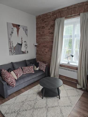a living room with a couch and a table at Kuninga Apartment in Old Town with Free Parking in Pärnu