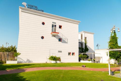 a white building with a sign on the side of it at Glemerald Hostel in Pula