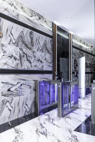 a marble wall in a hotel lobby with a counter at FLORIA - Sky Suites in Accra