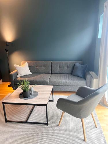 a living room with a couch and a table and a chair at City apartment in Alta