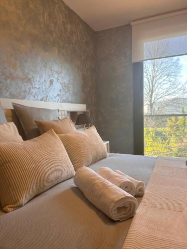a bedroom with a large bed with towels on it at Vivienda Turística Lorena in Cascante