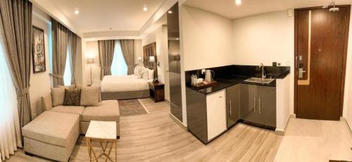 a living room with a couch and a bed in a room at Pak Hospitality in Islamabad