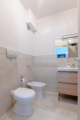 a bathroom with a toilet and a sink at Piccola Baia in Scopello