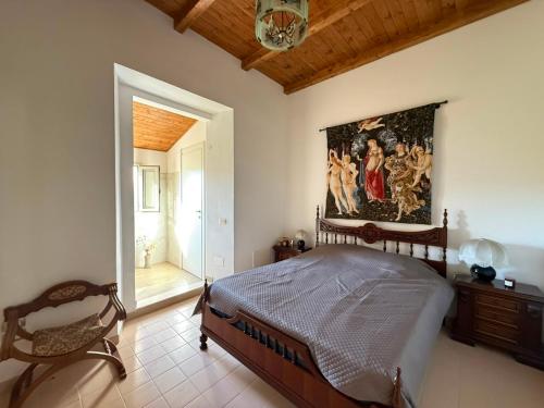 a bedroom with a bed and a painting on the wall at Casa Bella Tania in Briatico