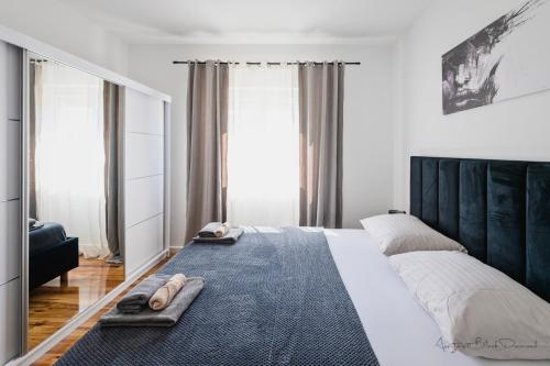 a bedroom with a large bed with slippers on it at Apartment Black Diamond in Ražanac