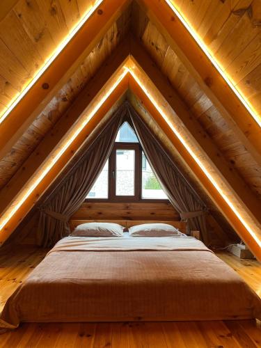 a bed in the attic of a wooden house at Underwoods_chill in Žabljak