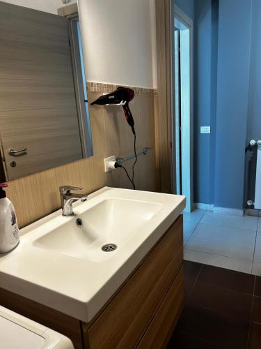 a bathroom with a white sink and a mirror at L'attico di Greta,Etna house in Mascalucia