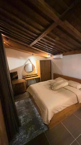 a bedroom with a large bed in a room at Nara Housee' in Darmasaba