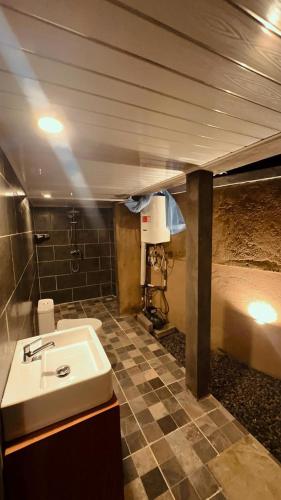 a bathroom with a sink and a tiled floor at Nara Housee' in Darmasaba