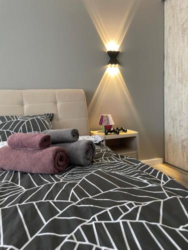 a bedroom with a bed with towels on it at Buiucani Residence in Chişinău