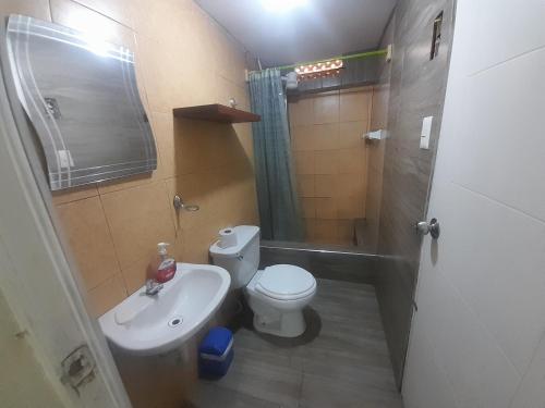 a bathroom with a toilet and a sink and a shower at Hospedaje Maljut in Lima