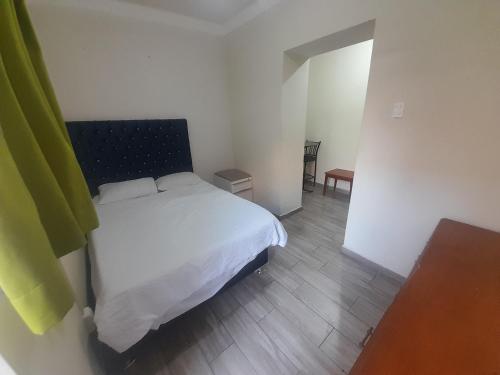 a bedroom with a white bed in a room at Hospedaje Maljut in Lima