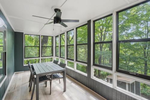 a dining room with windows and a table and chairs at Sharp Top Mountain Retreat in Jasper