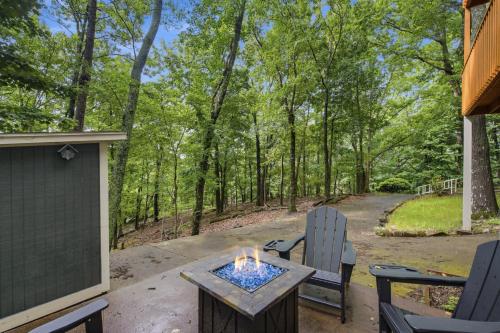a patio with two chairs and a fire pit at Sharp Top Mountain Retreat in Jasper