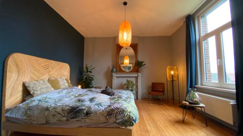 a bedroom with a bed with a cat laying on it at Le Clos Boréal - Gîte Spa Privatif in Lens