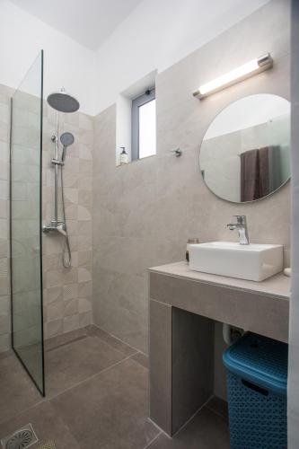 a bathroom with a sink and a mirror at GK Home Studios part of GK FITNESS CLUB in Faliraki