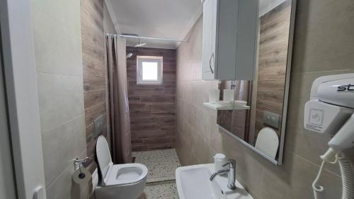 a bathroom with a toilet and a sink at Apartments BIA in Gevgelija