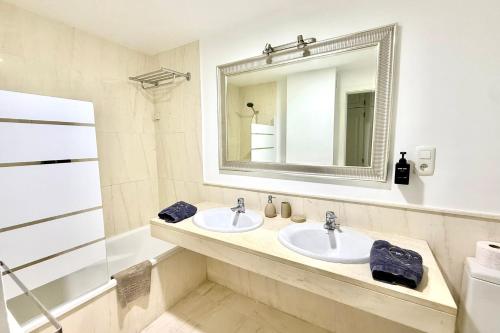 a bathroom with two sinks and a mirror at MI CAPRICHO BEACHFRONT 410 - Apartment with terrace and private garden by the sea in Mijas Costa