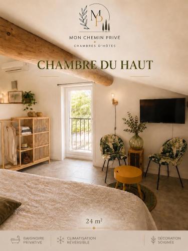 a room with a bed and two chairs and a television at Mon Chemin Privé in Mirabel-aux-Baronnies