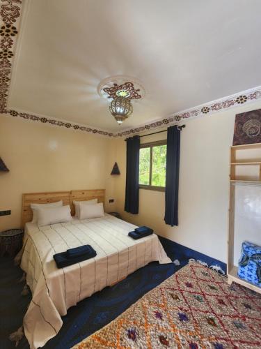 a bedroom with two beds and a large rug at Azul Atlas Lodge in Imlil