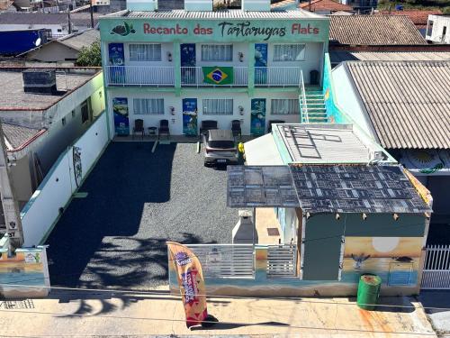 an overhead view of a building with a surfboard at Recanto das Tartarugas Flats in Penha