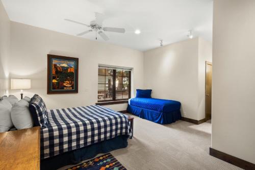 a bedroom with a bed and a blue couch at Mission Rock 2 in Ouray