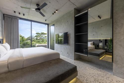 a bedroom with a large white bed and a fireplace at Predmet Kabakaba Resort in Tumbak Bayuh