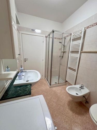 a bathroom with a toilet and a sink and a shower at Mas de le Contesse in Ton